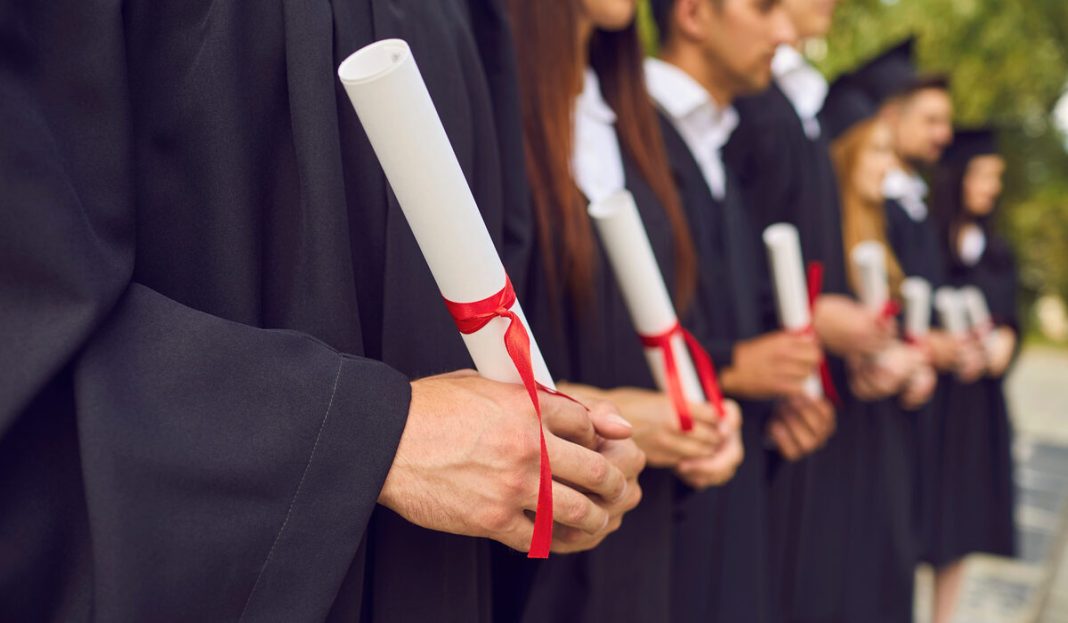 Close-up,Of,Young,University,Graduates,Hands,Holding,Diplomas,After,University